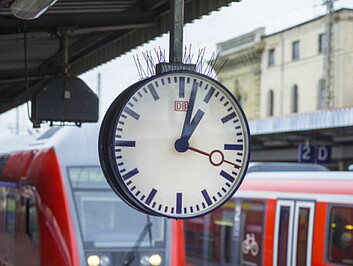 Bahngleis mit Zug und Uhr