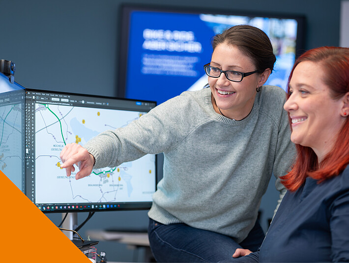 Zwei Frauen schauen auf einen Bildschirm